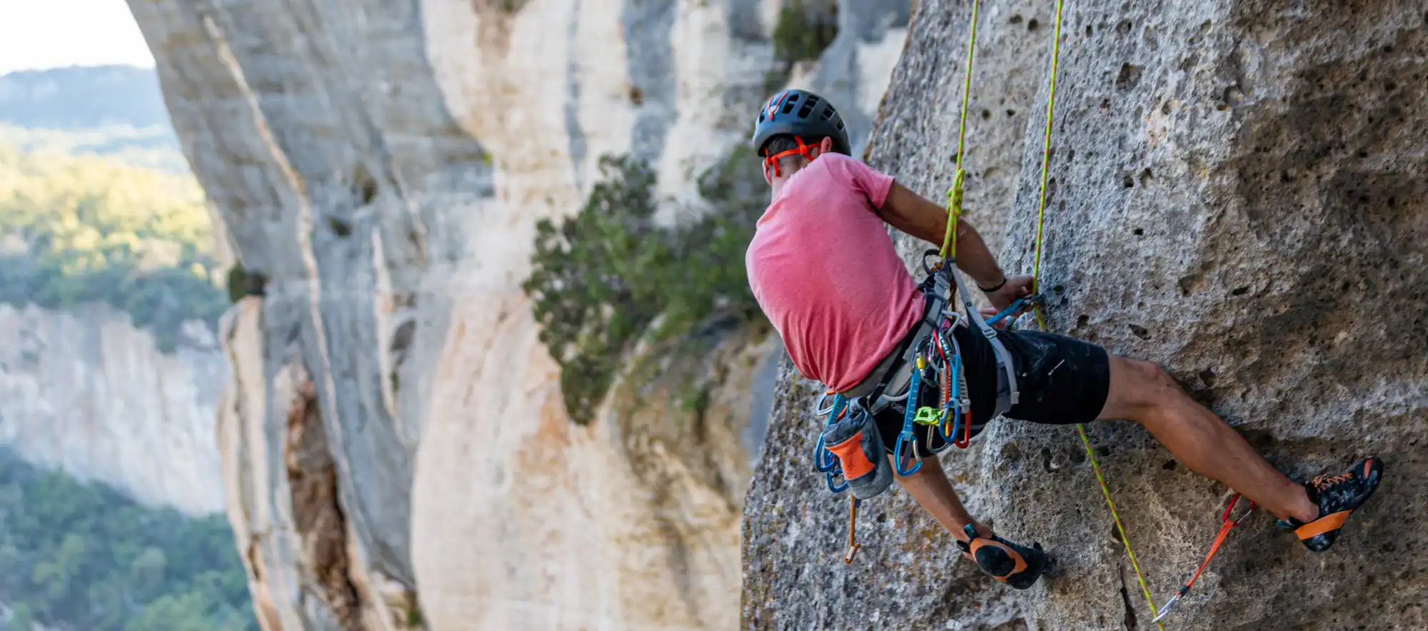 Sport climber on a limestone cliff, highlighting A2 pulley finger-injury risk on crimps.